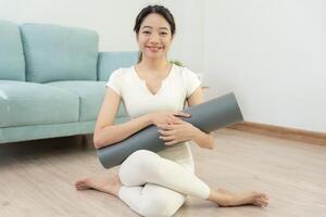 Portrait Slim asian woman smile after yoga at home. Asian woman doing exercises in morning. balance, meditation, relaxation, calm, good health, happy, relax, healthy lifestyle, diet, slim photo