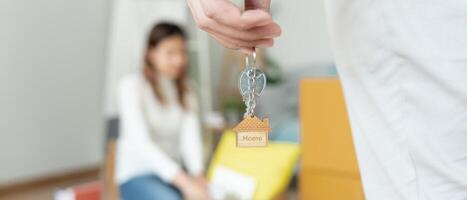 Moving house, relocation. Husband hold key house keychain in new apartment. move in new home. Buy or rent real estate. flat tenancy, leasehold property, new landlord, investment, dwelling, loan photo