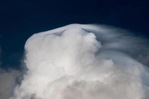 Big stormy clouds in a bright sunny day before sunset photo