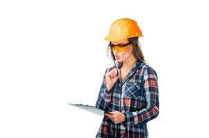 Woman Inspecting Construction Site. A woman wearing a hard hat and holding a clipboard photo