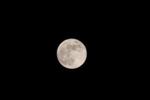 Full Moon Shining Bright In The Sky During The Night. photo