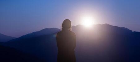 Young traveller is looking at the panoramic view while exploring in the mountain area for surveying and freedom, discovering the rare biological and ecologist on the field study and outdoor at sunrise photo