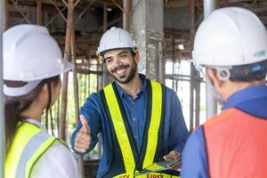 Engineering manager is giving thumbs up to contractor and foreman in meeting and consulting at construction building site for inspection in real estate development project industry and quality control photo