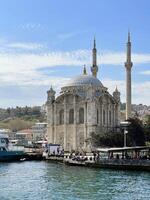 17 of April 2023 - Istanbul, Turkey - Ortakoy, Great Mecidiye Mosque, view from the sea photo