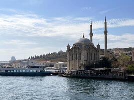 17 of April 2023 - Istanbul, Turkey - Ortakoy, Great Mecidiye Mosque, view from the sea photo