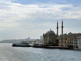 17 of April 2023 - Istanbul, Turkey - Ortakoy, Great Mecidiye Mosque, view from the sea photo