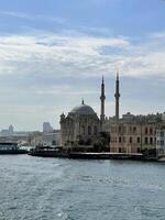 17 of April 2023 - Istanbul, Turkey - Ortakoy, Great Mecidiye Mosque, view from the sea photo