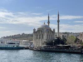 17 of April 2023 - Istanbul, Turkey - Ortakoy, Great Mecidiye Mosque, view from the sea photo