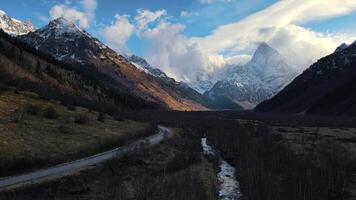 Aerial. a car drives along a road among the mountains video