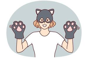 Funny woman in kitten mask demonstrates hands with gloves in form of kitty paws. Vector image