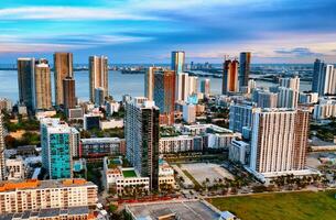 Aerial View of Miami City With Tall Buildings. An awe-inspiring aerial view of Miami, USA, showcasing its towering skyline and majestic buildings. photo