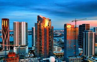 A Breathtaking Sunset View of Miamis City Skyline. Capture the beauty of Miamis city skyline at sunset from an aerial perspective. photo