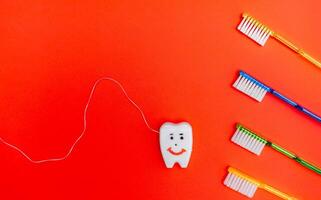 Toothbrushes and Toothpaste on a Red Background photo