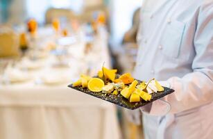 A Person Holding a Tray of Food on a Table photo