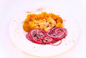 A Plate of Fresh and Colorful Vegetable Slices. A white plate topped with sliced up vegetables photo