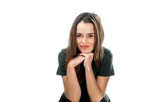 Contemplation at the Table. A woman sitting at a table with her hand on her chin photo