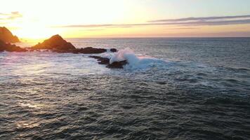 Aerial view of huge water rolling onto underwater rocks. video