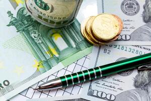 A Table with a Pen and Money. A pen and some money on a table photo