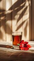AI generated Warm Light Casting Shadows on Glass of Tea and Hibiscus photo