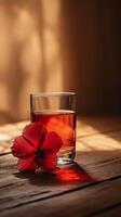 AI generated Elegant Glass of Tea with Vibrant Red Hibiscus Flower photo