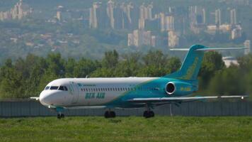 ALMATY, KAZAKHSTAN - MAY 5, 2019. Airplane Fokker 100, UP-F1005 of Bek Air takeoff, side view. Passenger plane departure video