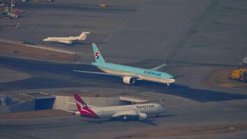 HONG KONG - NOVEMBER 09, 2019. Dreamliner Boeing 787 of Qantas taxiing at Hong Kong airport, top view. Qantas Airways Limited is an Australian airline. Korean Air on the taxiway video