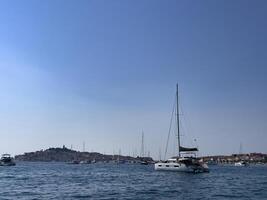 Sailboat. Sailing. Anchored. Blue sea. Wind. Adriatic sea. Catamaran. photo