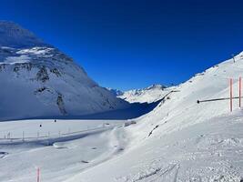 a person skiing down a snowy mountain photo