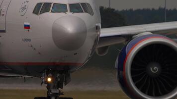 MOSCOW, RUSSIAN FEDERATION - JULY 29, 2021. Boeing 777 of Aeroflot taxiing, close-up, cockpit. Widebody aircraft on the taxiway. The aircraft is named Anton Chekhov. Concept aviation video