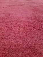 Old red carpet fabric texture and background seamless photo