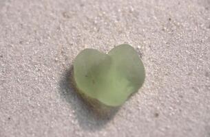 Heart Shaped Light Green Sea Glass on Sand photo