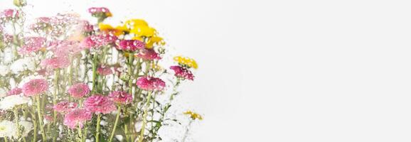 Bright and colorful bouquet seen through the glass with waterdrops. photo