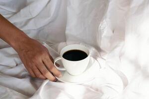 Coffee in bed. Enjoy morning at home. photo