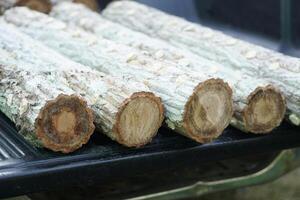 Wooden logs, prepared for construction or making firewood. Cut trees from forest. Concept, deforestation. Timber wood. photo