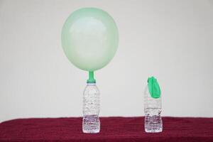 Science experiment , inflated balloons and flat balloon on top of transparent test bottles. Concept, science experiment about reaction of chemical substance. photo