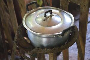 old rusty iron pot for cooking photo