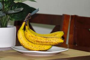 Ripe Banana bunch with Dark Spots on Table 1 photo