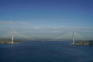 Yavuz Sultan Selim Bridge over the Bosphorus and Garipce village, Istanbul, Turkey. photo