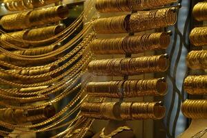 gold shop windows at istanbul grand bazar or Kapali Carsi, Turkey. Jewelry in the store window. A lot of luxury jewelry in the oriental market. Concept of shopping in Middle East. photo