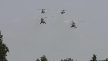 Military helicopters flying in sky performing demonstration flight, airforce, copy space. Group combat helicopters, aerobatic team performs flight at air show video