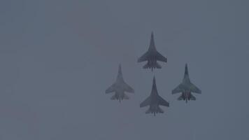 Jet fighters flying over the clouds, bottom view. Demonstration air show of military equipment video