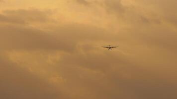 Commercial turboprop aircraft approaching landing, front view. Aircraft in the sky. Jet airliner turn for approach at background video