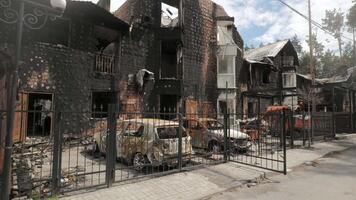 Burnt houses and cars as a result of artillery or rocket fire by the Russian army in the Kiev region. Russian invasion of Ukraine. video