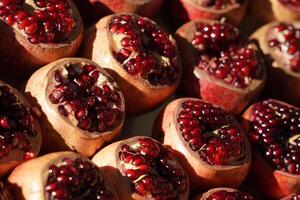 Cut pomegranate fruit in a fruit and vegetable outdoor shop. Turkish pomegranate fruits. Healthy diet concept. photo