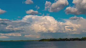 Epic storm clouds at sunset above a river. Time lapse. video