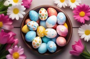 AI generated Easter, colorful painted eggs decorated with ornaments and patterns, pink spring flowers, daisies, eggs in a wicker nest, top view, wooden background photo