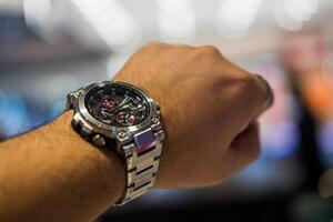 BANGKOK, THAILAND - FEBRUARY 5, 2024 Casio G-Shock model MTG-B1000D-1ADR on man hand. photo