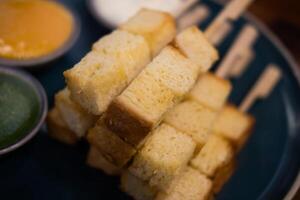 Slightly golden toast cut square, just the right size put in a stick photo