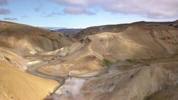 Aerial view of Kerlingarfjoll geotermal area. Steam rises from hot springs over the volcanic landscape. Iceland. 4K video