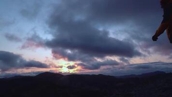 silhouette di un' uomo in piedi su superiore di il montagna nel Islanda. uomo raccolta braccia vittoriosamente dopo arrampicata il montagna. lento movimento video